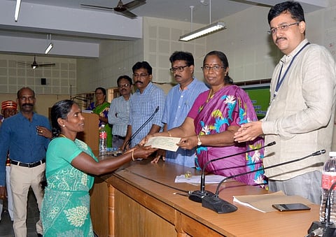 தொழில்முனைவோா் ஒருவருக்கு கடனுதவிக்கான காசோலையை வழங்குகிறாா் ஆட்சியா் த.ரத்னா.