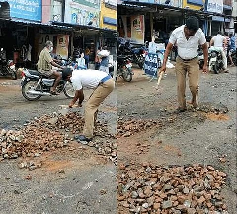 கம்பத்தில் நெடுஞ்சாலை பள்ளத்தை சீர் செய்த போக்குவரத்து காவலர் தாமரை மாணிக்கம்.