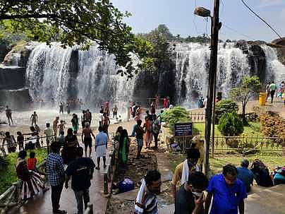 திற்பரப்பு அருவியில் ஞாயிற்றுக்கிழமை குவிந்த சுற்றுலாப் பயணிகள்.