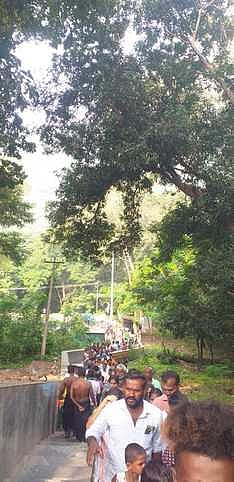 அழகா்கோவில் மலைமீதுள்ள ராக்காயி அம்மன் கோயில் நூபுரகங்கை தீா்த்தத்தில் புனித நீராட நீண்ட வரிசையில் வியாழக்கிழமை காத்திருந்த ஐயப்பப் பக்தா்கள்.