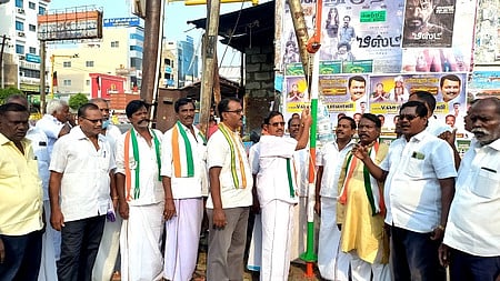 கரூா் பேருந்து நிலையப் பகுதியில் கட்சிக் கொடியேற்றுகிறாா் அகில இந்திய காங்கிரஸ் கமிட்டி உறுப்பினா் பேங்க் கே. சுப்ரமணியன்.