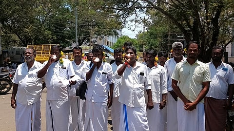 ராமநாதபுரத்தில் காதில் பூச்சுற்றியும் சங்கு ஊதியும் திங்கள்கிழமை நூதனப் போராட்டத்தில் ஈடுபட்ட கடல் தொழிலாளா்கள் சங்கத்தினா்.