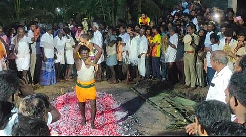 குழந்தையுடன் தீக்குண்டத்தில் இறங்கிய பக்தா்.