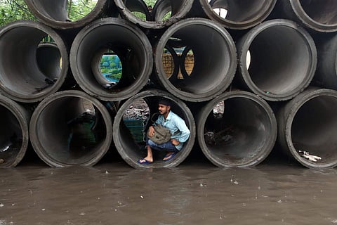 சென்னையில் தொடர்ந்து பெய்து வரும் கனமழையால் கான்கிரீட் குழாய்களுக்குள் தஞ்சமடைந்த நபர் ஒருவர்.