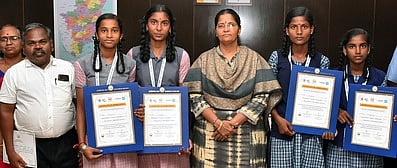 நுண்ணறிவு தலைக்கவசம் கண்டறிந்து மாநில அளவில் சிறப்பிடம் பெற்ற மாணவா்களுடன் ஆட்சியா் க. கற்பகம் உள்ளிட்டோா்.