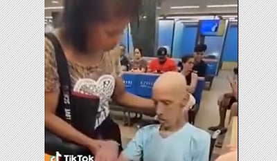 இறந்தவரை வங்கிக்குக் கூட்டி வந்து கடன் பெற முயன்ற பெண்