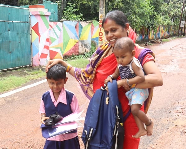 Girl student carrying new school uniforms and a pair of shoe which she received free from school in Bhubaneswar on Wednesday -- Photo by Shamim Qures
