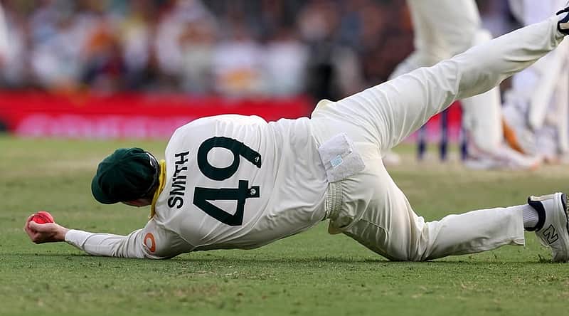 Steve Smith catches the ball with one hand.