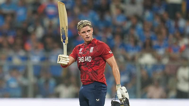England's Jacob Bethell celebrates after scoring a century during the T20 World Cup cricket semi-final match between India and England in Mumbai, India, Thursday, March 5, 2026. (AP Photo/Rafiq Maqbool)