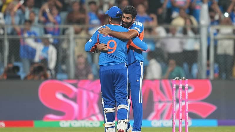 India's Jasprit Bumrah, right, hugs teammate Sanju Samson to celebrate their win in the T20 World Cup cricket semi-final match against England in Mumbai, India, Thursday, March 5, 2026. (AP Photo/Rafiq Maqbool)