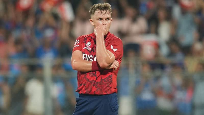 England's Sam Curran reacts after India's Sanju Samson hit a boundary on his delivery during the T20 World Cup cricket semi-final match between India and England in Mumbai, India, Thursday, March 5, 2026. (AP Photo/Rafiq Maqbool)