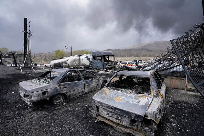 Burned vehicles sit near an oil storage facility struck by a U.S.-Israeli attack