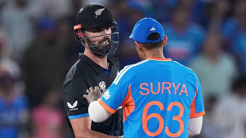 India's captain Suryakumar Yadav, right, talks to New Zealand's Daryl Mitchell, who is annoyed after a misguided throw from India's Arshdeep Singh hit his bat during the T20 World Cup cricket final match between India and New Zealand in Ahmedabad, India, Sunday, March 8, 2026. (AP Photo/Ajit Solanki)