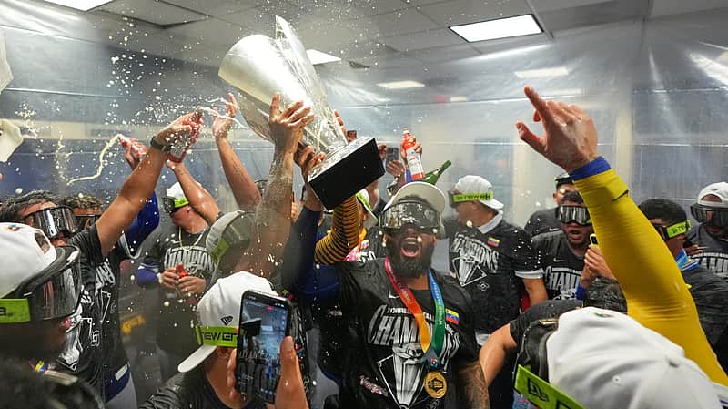 The Venezuela team celebrate with the trophy after defeating the United States in the championship game of the World Baseball Classic, Tuesday, March 17, 2026, in Miami. (AP Photo/Rebecca Blackwell)