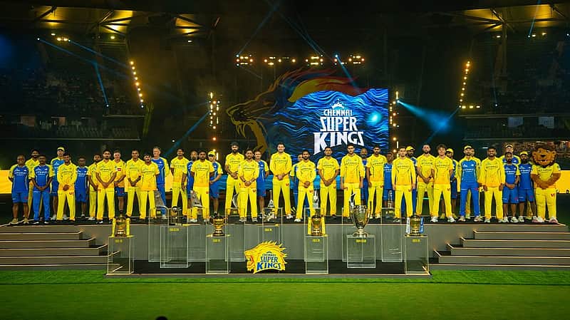 CSK team with IPL trophies.