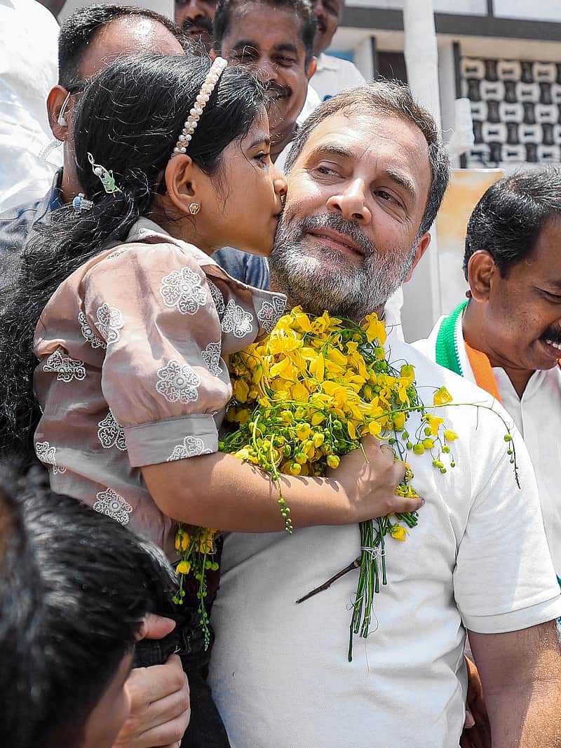  Lok Sabha LoP Rahul Gandhi interacts with a little girl during a corner meeting in Adoor, in Pathanamthitta on Monday. (AICC/ANI Photo)
