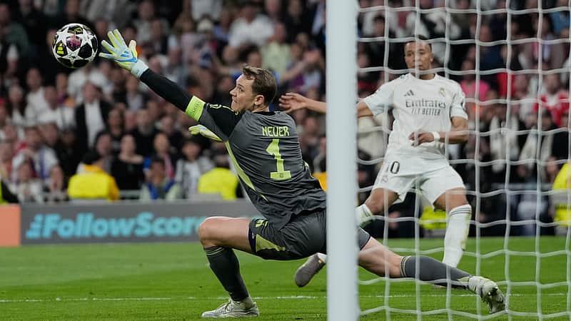 Bayern's goalkeeper Manuel Neuer tries to save a shot by Real Madrid's Kylian Mbappe during the Champions League quarterfinal first leg soccer match between Real Madrid and Bayern Munich in Madrid, Spain, Tuesday, April 7, 2026. (AP Photo/Bernat Armangue)
