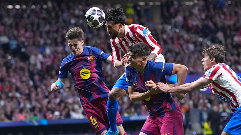 Atletico Madrid's Nicolas Gonzalez, top, heads the ball during the Champions League quarterfinal second leg soccer match between Atletico Madrid and Barcelona in Madrid, Spain, Tuesday, April 14, 2026. (AP Photo/Manu Fernandez)