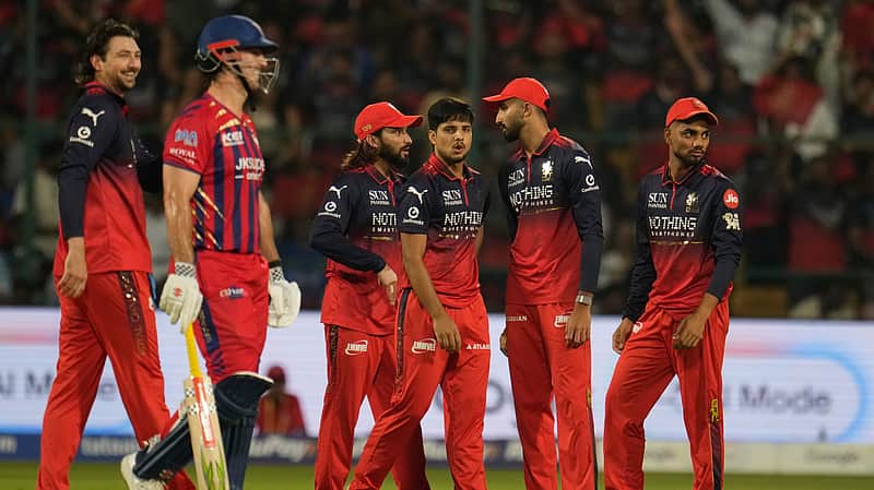 RCB players celebrating after taking a wicket.