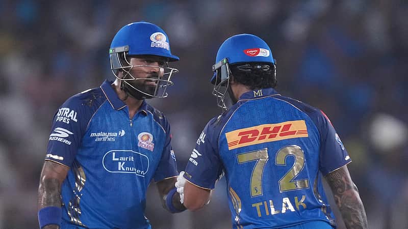 Mumbai Indians' Tilak Verma, right, celebrates his fifty runs with captain Hardik Pandya during the Indian Premier League cricket match between Gujarat Titans and Mumbai Indians in Ahmedabad, India, Monday, April 20, 2026.(AP Photo/ Ajit Solanki )