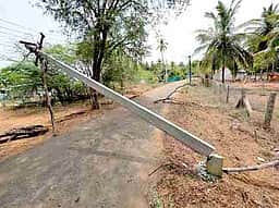 சாலையின் குறுக்கே கிடக்கும் மின் கம்பம் 3 நாள்களாக தொடரும் மின் தடை