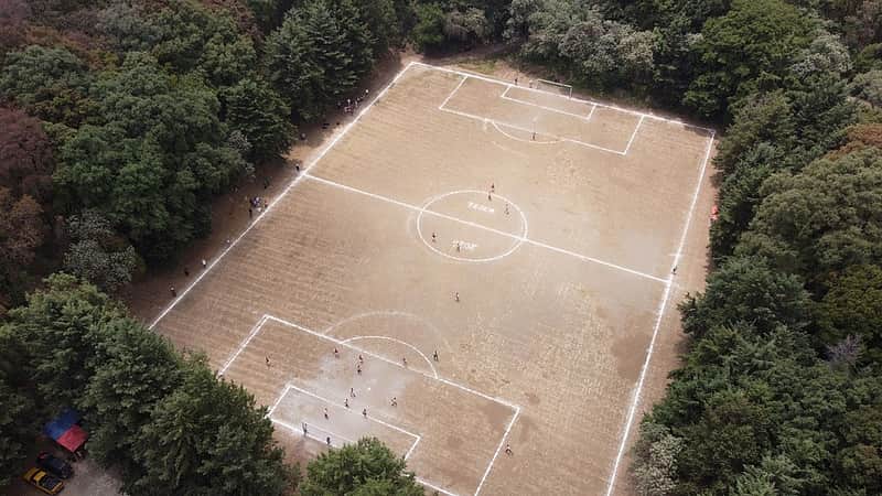 A soccer field nestled inside the crater of the extinct Teoca volcano hosts a local tournament match in the town of Santa Cecilia Tepetlapa in the Xochimilco borough of Mexico City, Sunday, April 19, 2026. (AP Photo/Eduardo Verdugo)