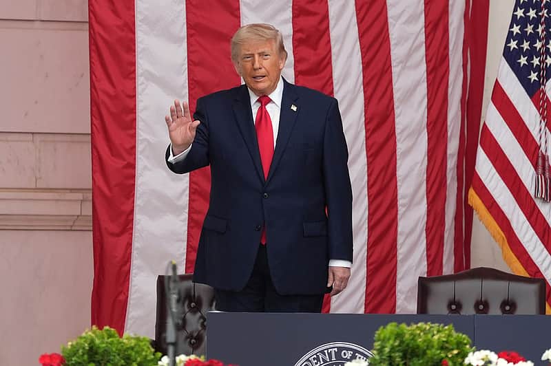 President Donald Trump waves to the audience during the 158th National Memorial Day Observance coinciding with the nation's 250th anniversary, at the Memorial Amphitheater in Arlington National Cemetery, Monday, May 25, 2026, in Arlington, Va. (AP Photo/Alex Brandon)