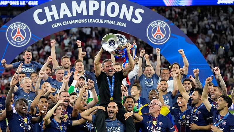 PSG's head coach Luis Enrique lifts the trophy celebrating after winning the Champions League final soccer match between Paris Saint-Germain and Arsenal in Budapest, Hungary, Saturday, May 30, 2026. (AP Photo/Petr Josek)