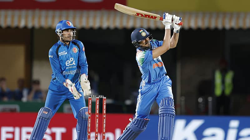 Shubman Gill smashing the ball for a six.
