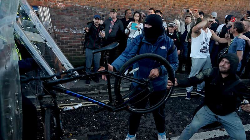 In this image taken from PA Video, police and protestors clash during a protest following the death of Henry Nowak, a 18-year-old student stabbed to death with a Sikh kirpan ceremonial by Vickrum Digwa, in Southampton, England, Tuesday June 2, 2026. (Jamie Lashmar/PA via AP)