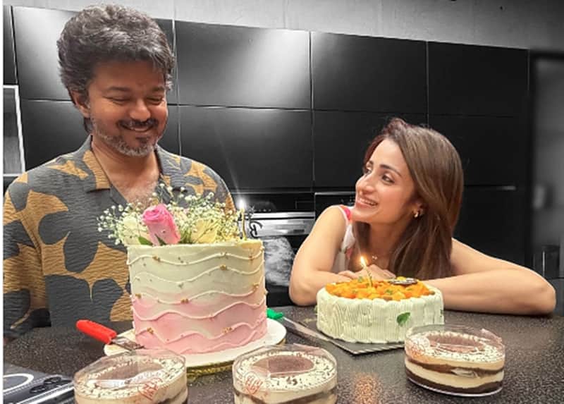 Trisha cuts a cake with Chief Minister joseph Vijay