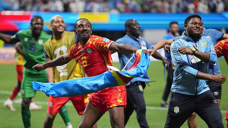 Congo's Samuel Moutoussamy (8) joins other teammates, coaches, and stff in celebrating a win after the World Cup Group K soccer match between DR Congo and Uzbekistan in Atlanta, Saturday, June 27, 2026. (AP Photo/Jacob Kupferman)