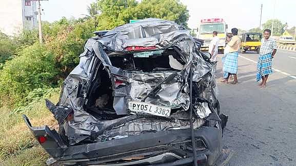 லாரி மோதியதில் சேதமடைந்த காா்.
