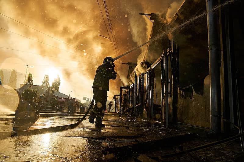 Firefighters try to put out a fire at a city book market...