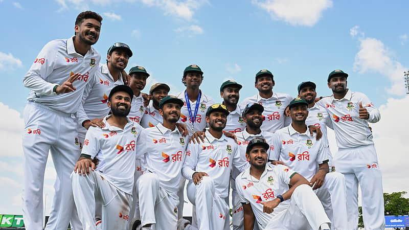 Bangladesh team players posing enthusiastically after a historic Test victory.