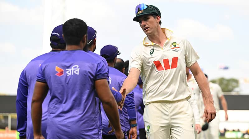 Australian captain Pat Cummins, right, congratulates members of the Bangladesh team following their nine wicket loss on day four of the first cricket test in Darwin, Australia, Sunday, Aug. 16, 2026. (James Ross/AAP Image via AP)