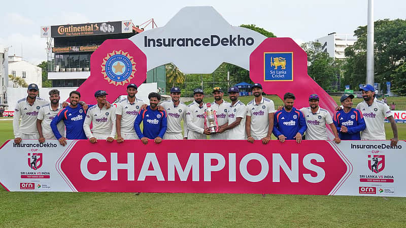 Indian team players posing with the trophy.