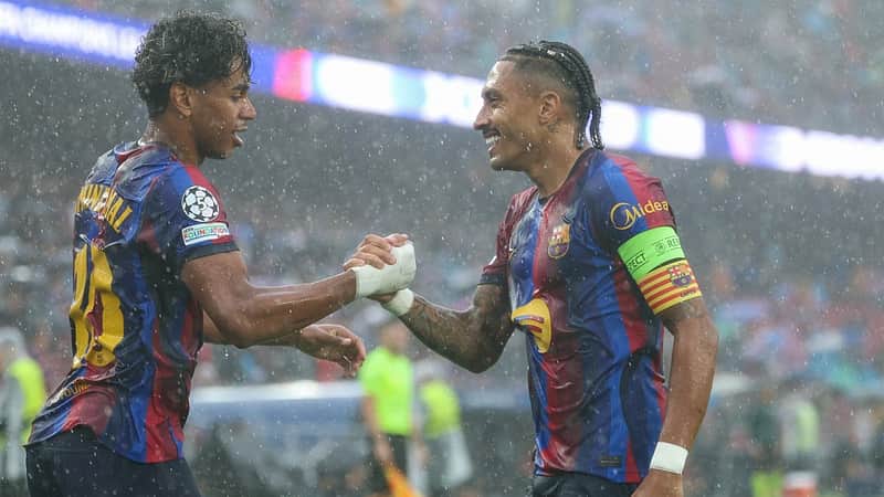 Barcelona's Brazilian forward #11 Raphinha (R) celebrates scoring his team's first goal with teammate Barcelona's Spanish forward #10 Lamine Yamal during the UEFA Champions League first round day 1 football match between FC Barcelona and Feyenoord at Camp Nou stadium in Barcelona on September 9, 2026. (Photo by Lluis GENE / AFP)