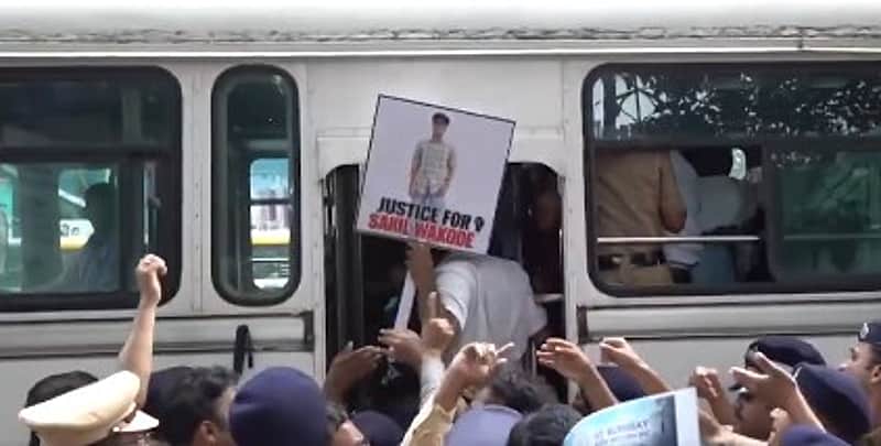 As the protesters were being loaded into the police vehicle