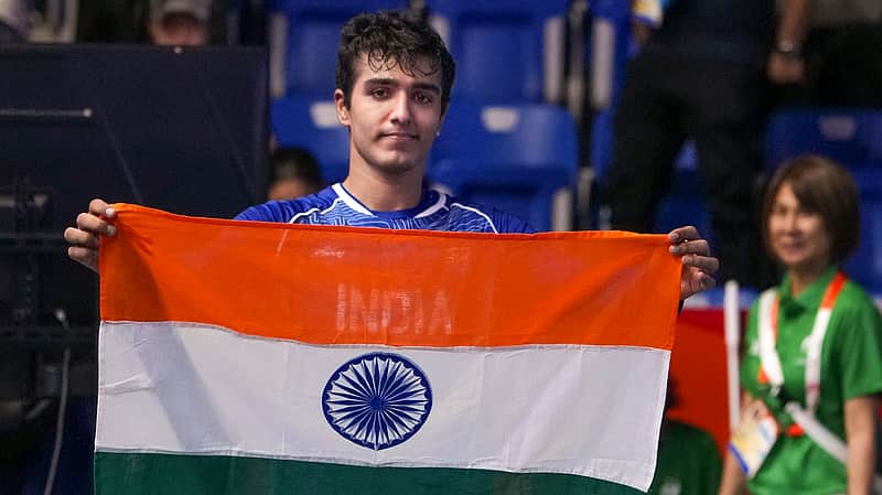 Nagoya: Indias Abhay Singh holds the national tricolour flag after winning the mens singles semifinal Squash match against Pakistans Muhammad Irfan in the ongoing 20th Asian Games, in Nagoya, Japan, Saturday, Sept. 26, 2026. (PTI Photo/Arun Sharma)(PTI09_26_2026_000138B)