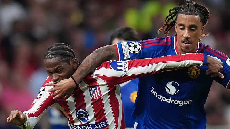 Manchester United's Leny Yoro, right, fouls Atletico Madrid's Jonathan David during the Champions League opening phase soccer match between Atletico Madrid and Manchester United in Madrid, Tuesday, Oct. 13, 2026. (AP Photo/Bernat Armangue)