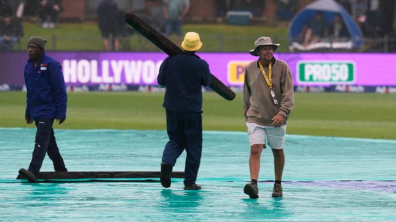 Groundsmen walk on the covers as rain delays match on day one of the second cricket test match between South Africa and Australia, in Gqeberha, South Africa, Sunday, Oct. 18, 2026. (AP Photo/ Themba Hadebe)