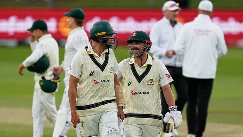 Australia's Scott Boland, center left, and teammate Travis Head, center right, leave the field at the end of day's play on day four of the second cricket test match between South Africa and Australia, in Gqeberha, South Africa, Wednesday, Oct. 21, 2026. (AP Photo/Themba Hadebe)
