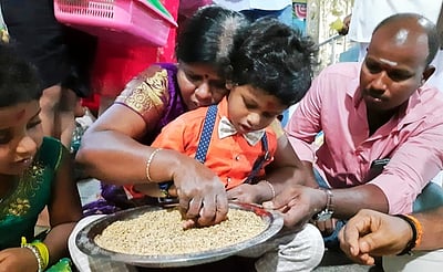 கூத்தனூா் சரஸ்வதி கோயிலில் வித்யாரம்ப வழிபாடுநெல்மணிகளில் எழுதப் பழகிய குழந்தைகள்