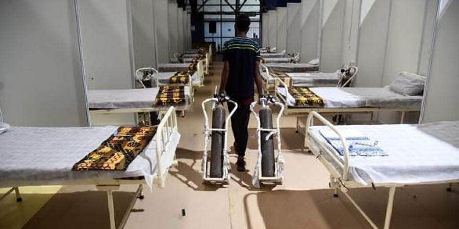 கரோனா நோயாளிகளுக்கு தலைசீவி, முகச்சவரம் செய்யும் முன்களப் பணியாளர்கள்